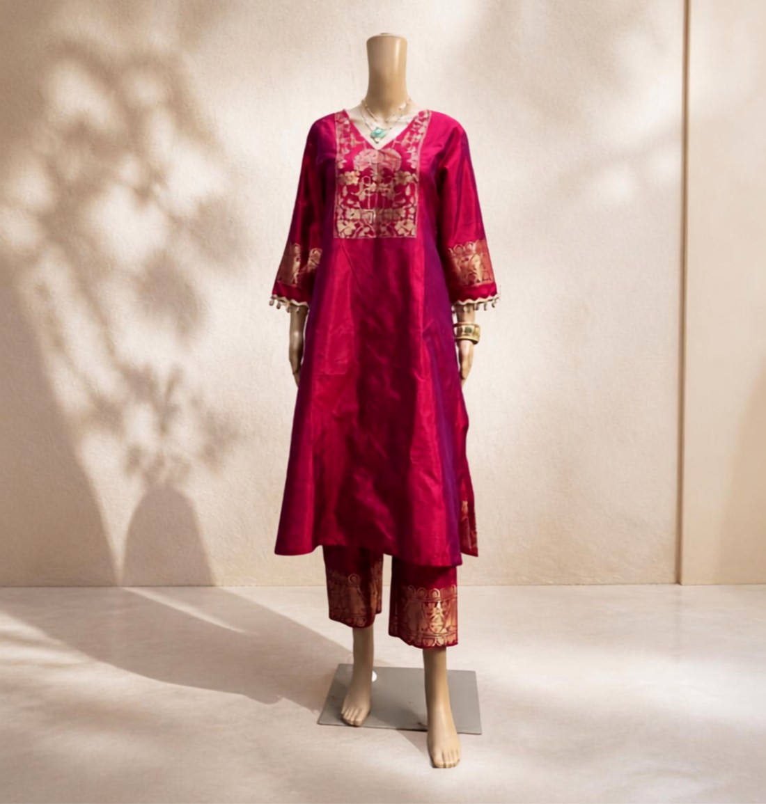 Model wearing a SILKWaala pink and gold embroidered silk suit